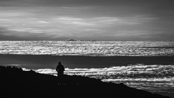 Mount Kilimanjaro photography, black-and-white silhouette, African landscape photography, Uhuru Peak art, fine art cloudscape, adventure photography, Kilimanjaro monochrome print, summit photography art, freedom silhouette photo, Tanzania photography art, luxury landscape prints